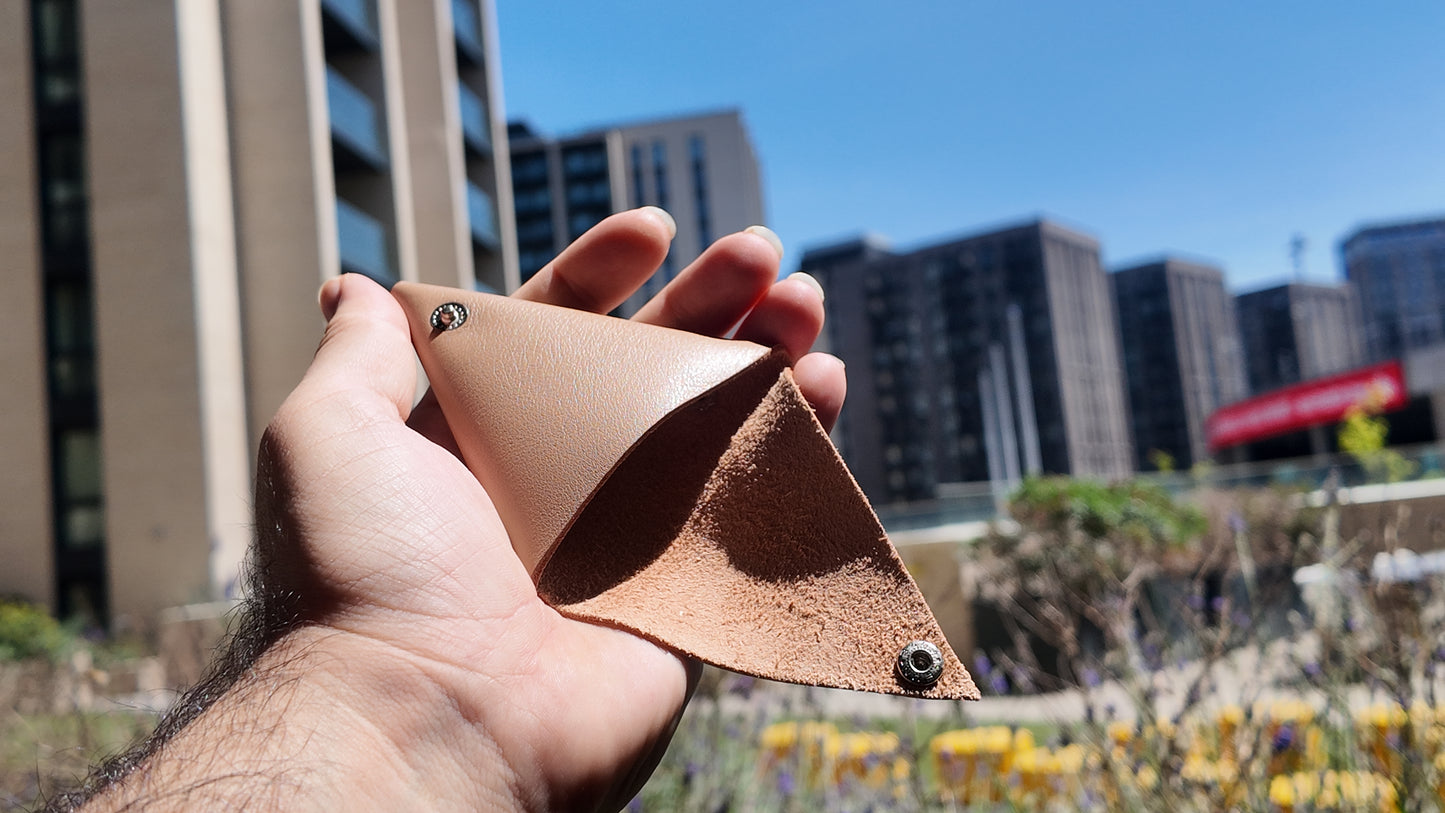 Open beige leather coin pouch showing its suede leather interior craftsmanship