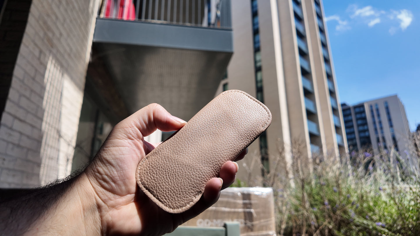 Back view of a handmade beige leather eyewear case highlighting its premium pebbled leather texture.
