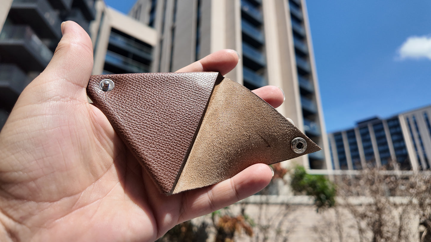 Open handmade brown leather coin pouch revealing its soft suede interior and handcrafted construction.