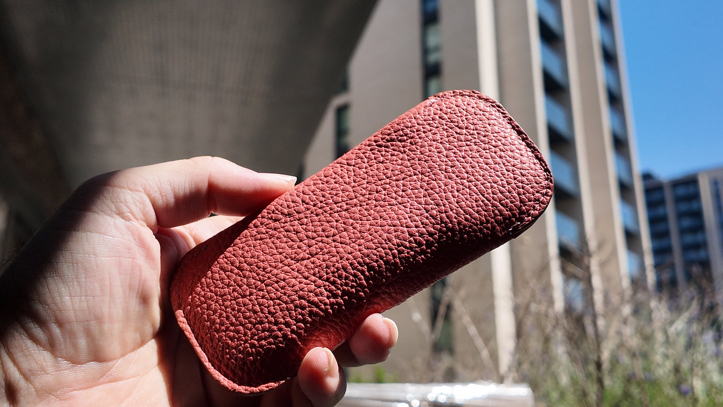 Back view of a handmade salmon pink genuine leather eyewear case highlighting its premium pebbled leather texture.