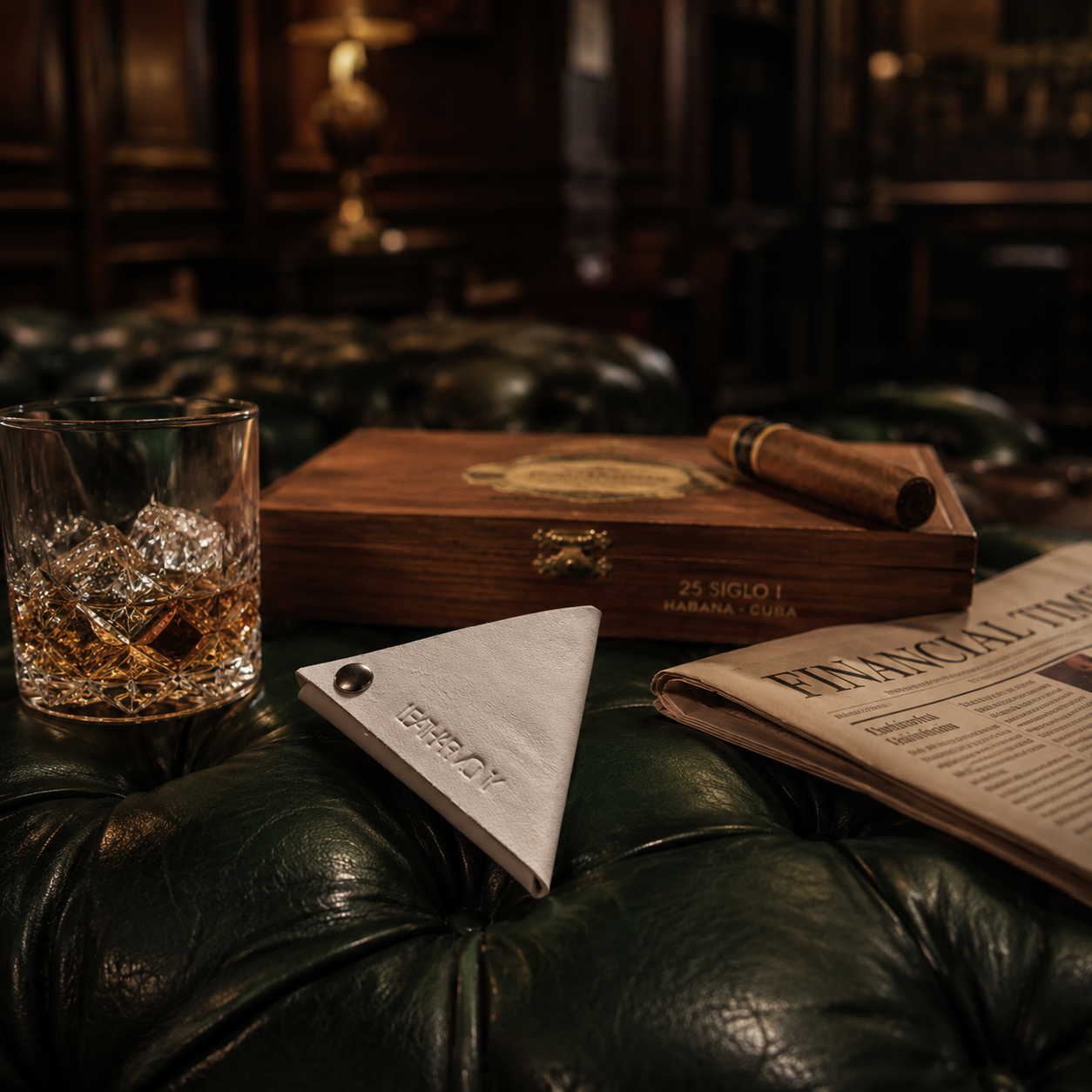 White genuine leather coin pouch styled with whisky, cigars and a luxury lounge setting.